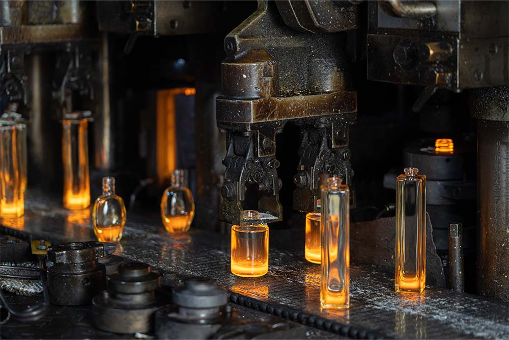 Hot glass bottles at forming equipment