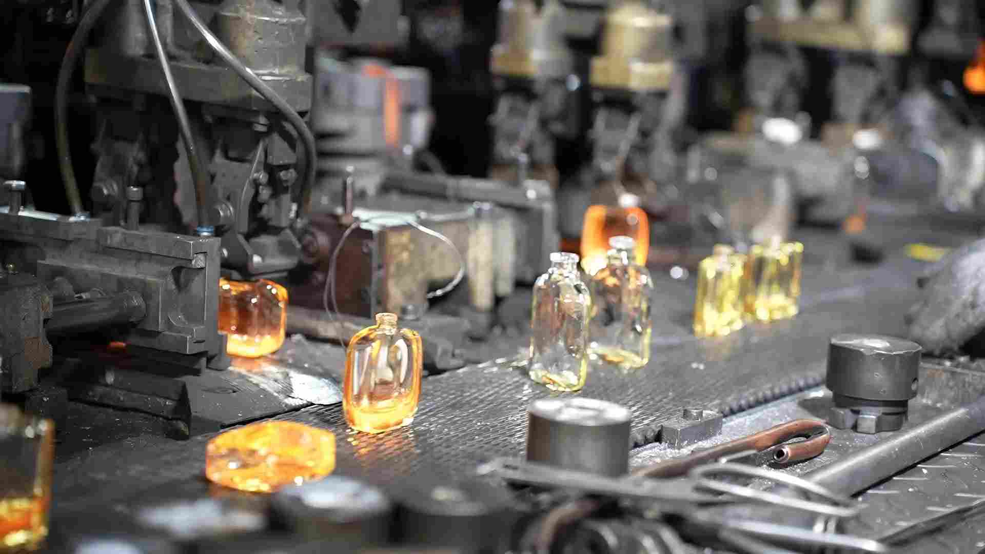 Glass perfume bottles on the factory forming line